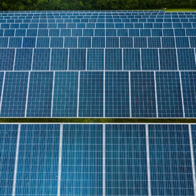 Contemporary installation of solar panels mounted on field in environmental friendly solar power station
